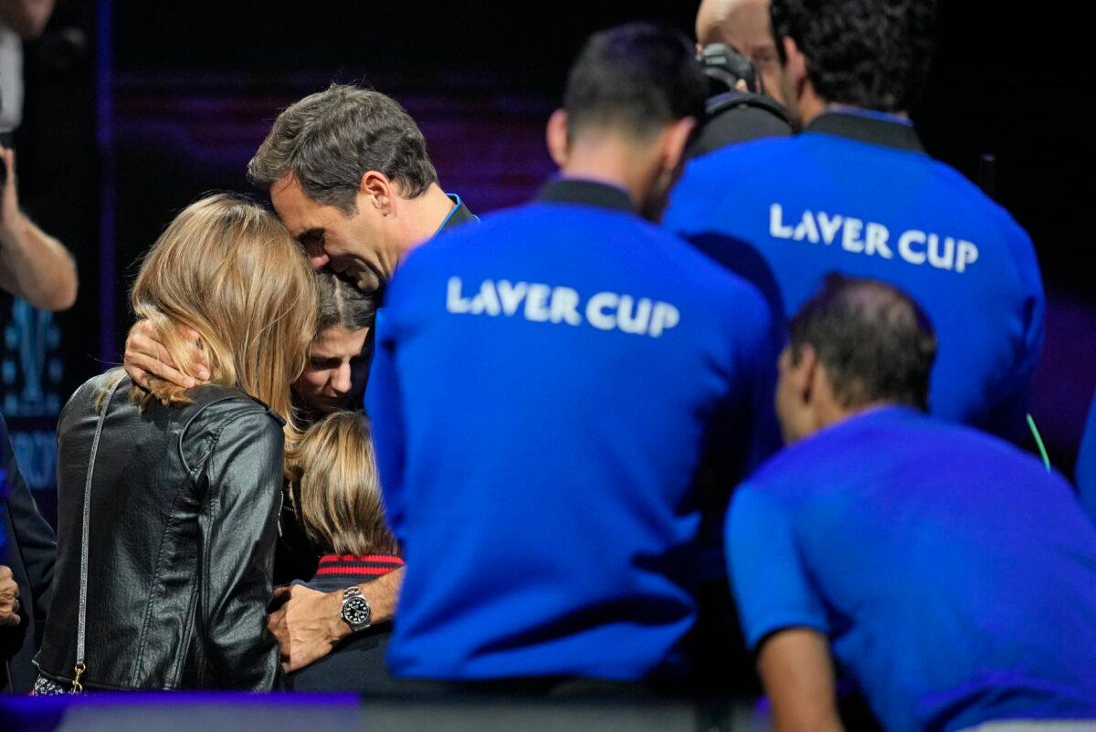 An emotional Roger Federer of Team Europe embraces his wife Mirka and their children after playing with Rafael Nadal in a Laver Cup doubles match against Team World's Jack Sock and Frances Tiafoe at the O2 arena in London on Sept. 23, 2022. (Kin Cheung/AP Photo)