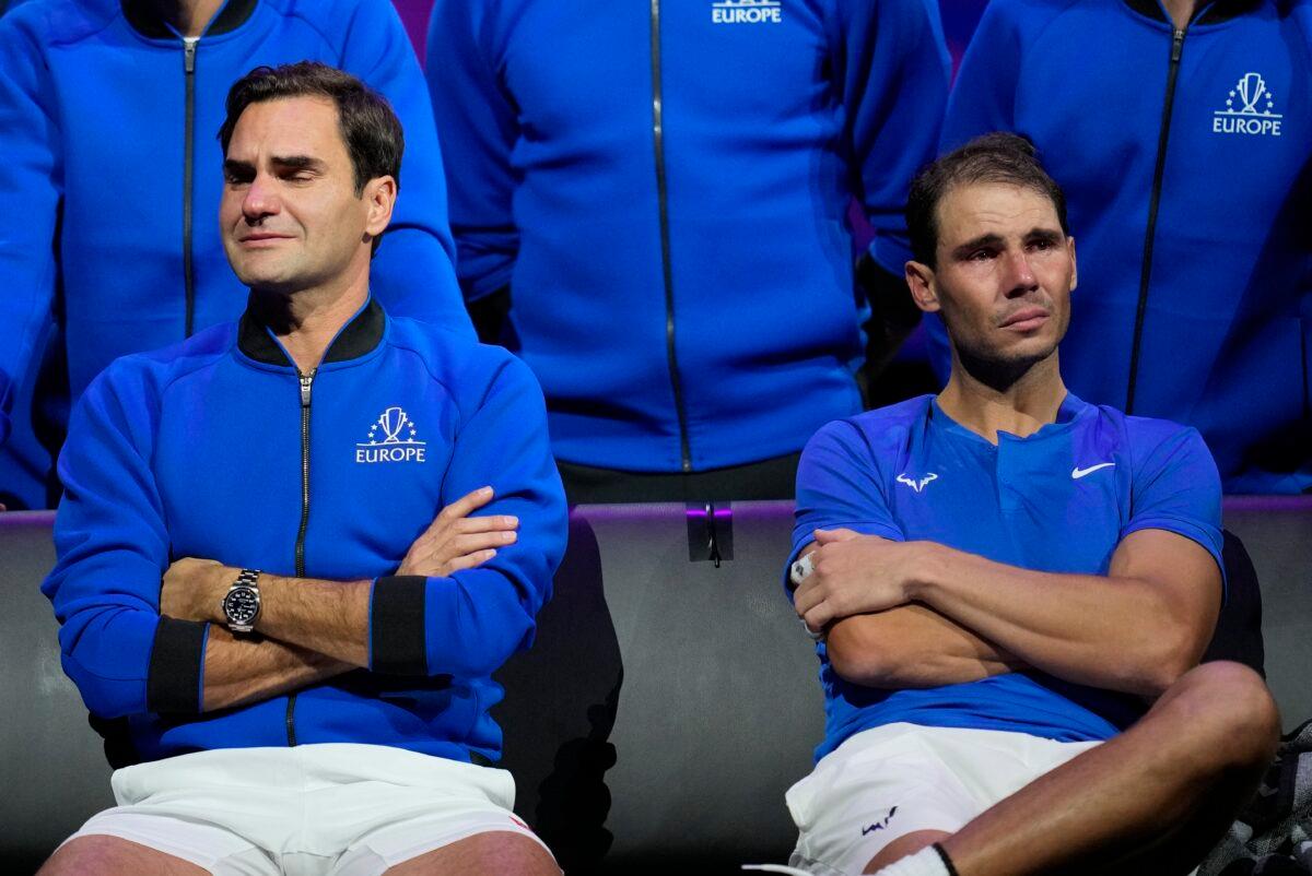 An emotional Roger Federer (L) of Team Europe sits alongside his playing partner Rafael Nadal after their Laver Cup doubles match against Team World's Jack Sock and Frances Tiafoe at the O2 arena in London on Sept. 23, 2022. (Kin Cheung/AP Photo)