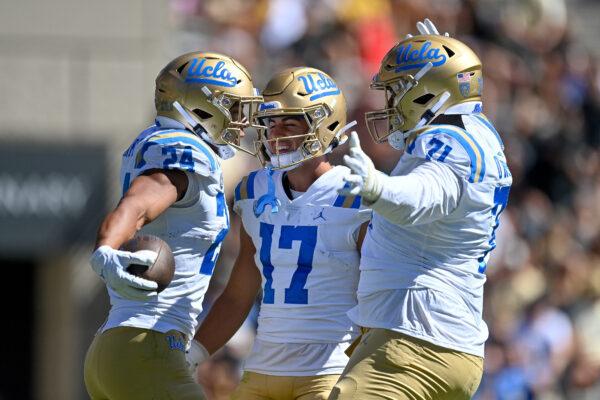 Running back Zach Charbonnet (24) of the UCLA Bruins celebrates with wide receiver Logan Loya (17) after a second quarter touchdown against the Colorado Buffaloes at Folsom Field in Boulder, Colo., on Sept. 24, 2022. (Dustin Bradford/Getty Images)