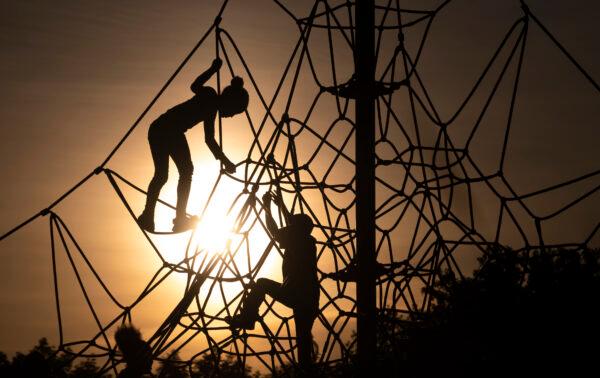 Children climb on play equipment at sunset in Liberty State Park on May 18, 2019 in Jersey City. (Johannes Eisele/Getty Images)