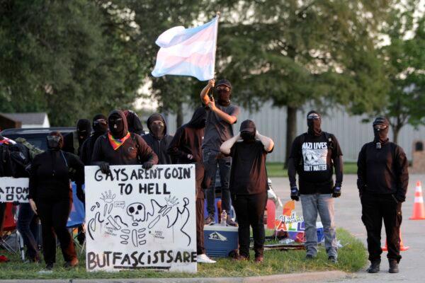 Members of Antifa taunt protestors across the street Sept. 24, 2022. (Bobby Sanchez/The Epoch Times)