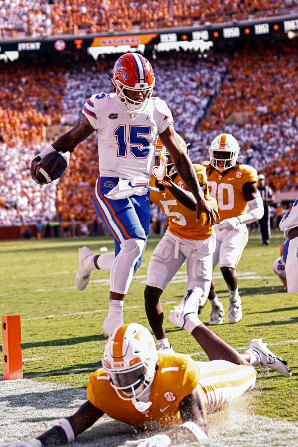 Florida quarterback Anthony Richardson (15) leaps into the end zone for a touchdown avoiding Tennessee defensive back Trevon Flowers (1) during the first half of an NCAA college football game in Knoxville, Tenn., Sept. 24, 2022. (Wade Payne/AP Photo)