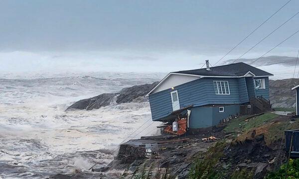 A home is hit by high winds caused by post-tropical storm Fiona in Port aux Basques, Newfoundland and Labrador, on Sept. 24, 2022. (Rene Roy/Wreckhouse Press via AP)