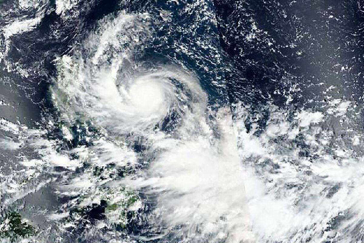 A satellite image shows Typhoon Noru approaching Philippines on Sept. 24, 2022. (NASA Worldview, Earth Observing System Data and Information System (EOSDIS) via AP)