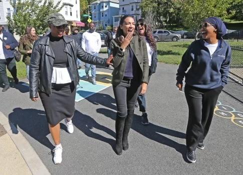 Members of The Squad walk down a street in Somerville, Mass., on Sept. 24. (Supplied)