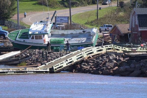A lobster boat grounded on the rocks at the wharf in Stanley Bridge, P.E.I., on Sept. 25, 2022.(The Canadian Press/Brian McInnis)