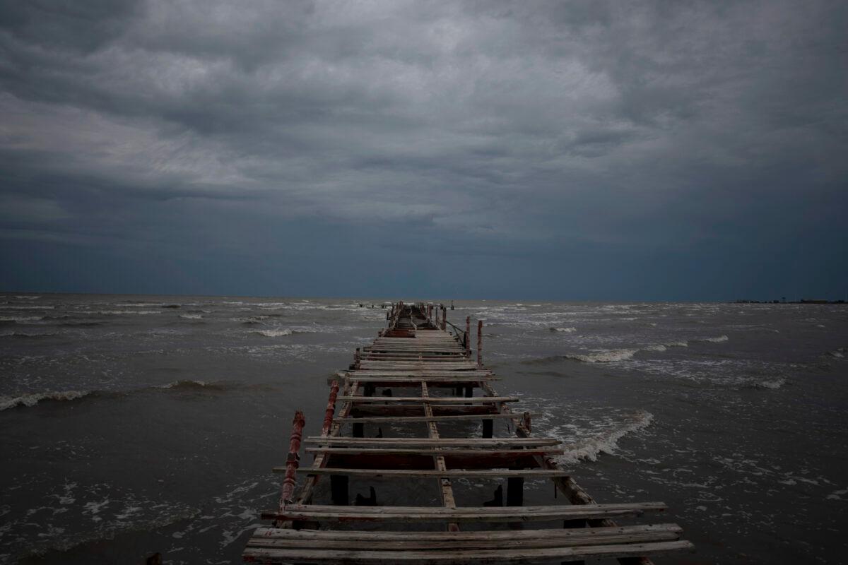 Waves kick up under a dark sky along the shore of Batabano, Cuba, on Sept. 26, 2022. (Ramon Espinosa/AP Photo)