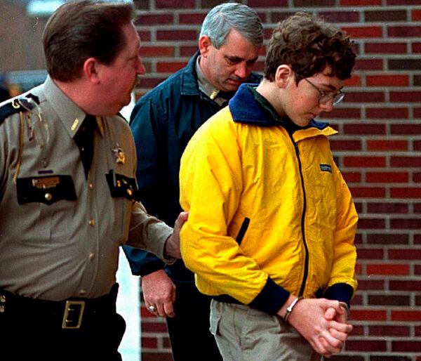 Heath High School shooting suspect Michael Carneal is escorted out of the McCracken County Courthouse after his arraignment in Paducah, Ky., on Jan. 15, 1998. (Sam Upshaw Jr./Courier Journal via AP)