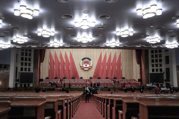 A woman walks out the meeting room after a plenary session of the Chinese People's Political Consultative Conference (CPPCC) at the Great Hall of the People in Beijing on March 11, 2013. The CPPCC is a key part of the Chinese regime's united front organization. (Feng Li/Getty Images)