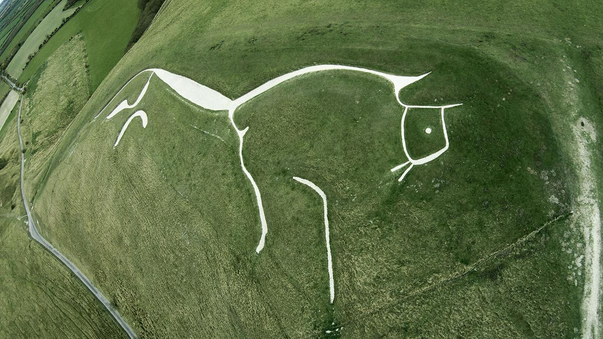 The Uffington White Horse, a chalk figure etched into an Oxfordshire hillside, has been carefully preserved for 3,000 years. (A G Baxter/Shutterstock)