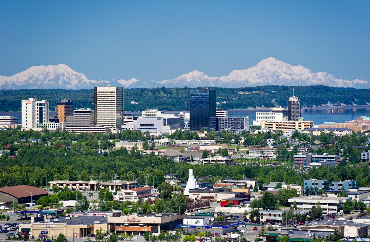 An aerial view of downtown Anchorage with the Alaska Range in the background. Denali is on the right. (Ken Graham Photography/Visit Anchorage)