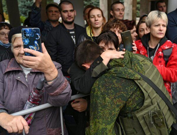 A woman says goodbye to a reservist drafted during partial mobilisation, before his departure for a military base, in the city of Bataysk, in the Rostov region, Russia Sept. 26, 2022. (Sergey Pivovarov/Reuters)