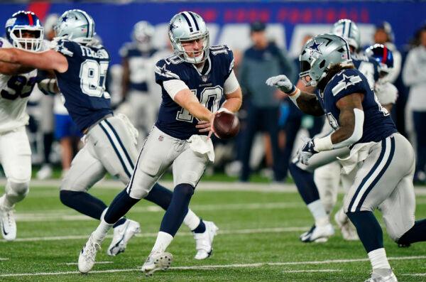 Dallas Cowboys quarterback Cooper Rush (10) hands off the ball to Dallas Cowboys running back Ezekiel Elliott (21) against the New York Giants during the second quarter of an NFL football game,<br/>in East Rutherford, N.J., Sept. 26, 2022. (Frank Franklin II/ AP Photo)