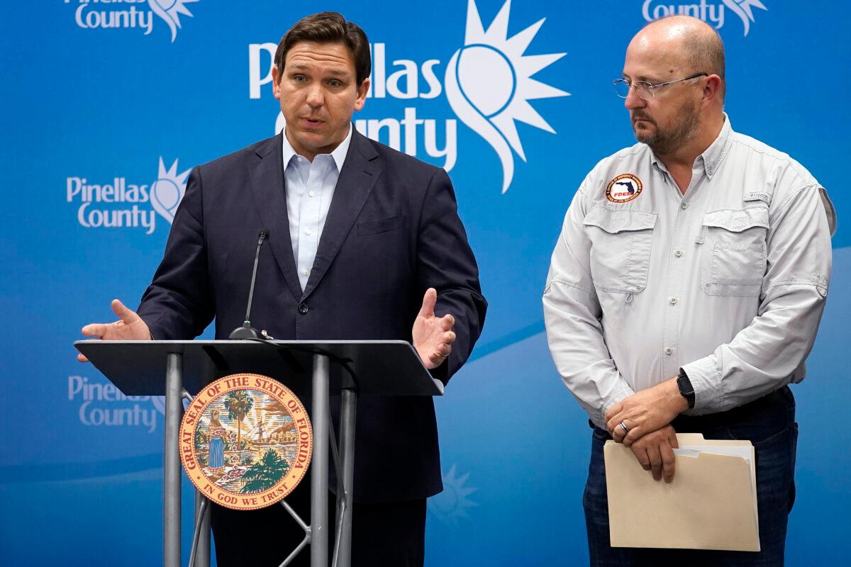 Florida Gov. Ron DeSantis (L) speaks as he stands with Kevin Guthrie, director of the Florida Division of Emergency Management, during a news conference in Largo, Fla., on Sept. 26, 2022. (Chris O'Meara/AP Photo)