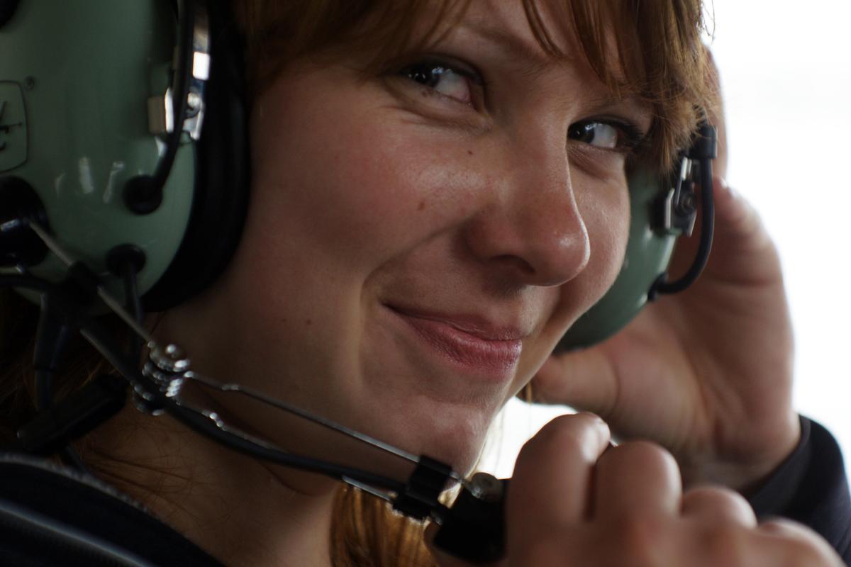 Setting up headphones and mic before takeoff on a flightseeing tour. (Mikhail Siskoff/Visit Anchorage)