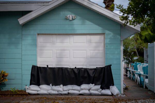 Sandbags are set up in front of a garage door as a flood precaution for Hurricane Ian in St. Pete Beach, Fla., on Sept. 26, 2022. (Ricardo Arduengo/AFP via Getty Images)