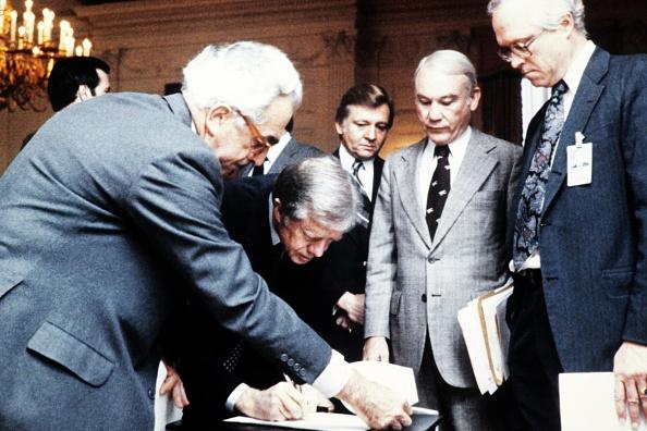 President Jimmy Carter (second L) signs the order blocking Iranian funds in U.S. banks during the hostage crisis in 1979. (AFP via Getty Images)