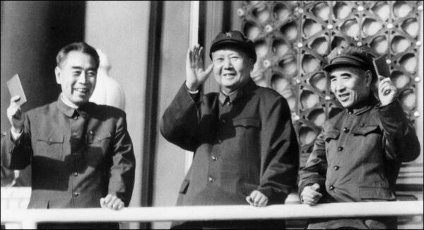 Top Chinese communist leaders Zhu Enlai (1898-1975), premier of the People's Republic of China from its inception in 1949 until his death, Mao Zedong (1893-1976), chairman of the Chinese Communist Party, and Lin Piao (1907-71), minister of defense,  wave "Little Red Books" as they review troops celebrating the 18 th anniversary of the Republic at Tiananmen Square in Beijing on Oct. 3, 1967. (AFP via Getty Images)