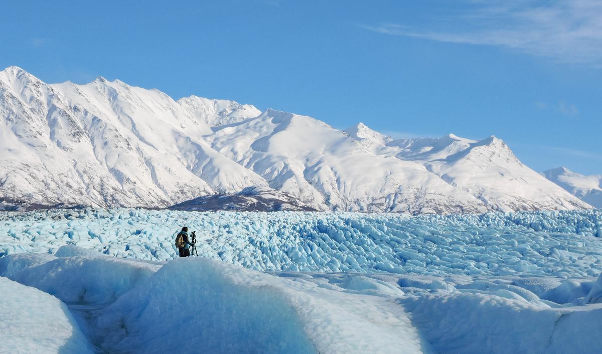 Filming Knik Glacier after a helicopter dropoff. (Ashley Heimbigner/Visit Anchorage)