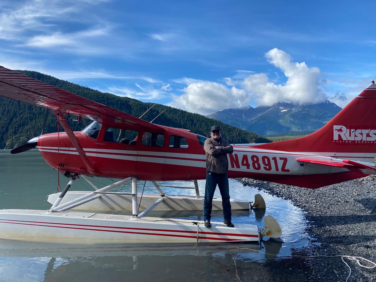 Pilot Brian Carlin standing on his float plane. (Tim Johnson)