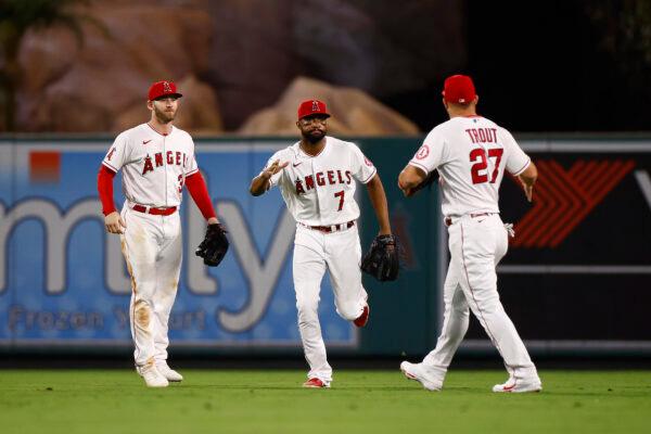 Jo Adell (7) of the Los Angeles Angels celebrates a 4-3 win with Taylor Ward (3) and Mike Trout (27) against the Oakland Athletics at Angel Stadium of Anaheim, in Anaheim, Calif., on Sept. 27, 2022. (Ronald Martinez/Getty Images)