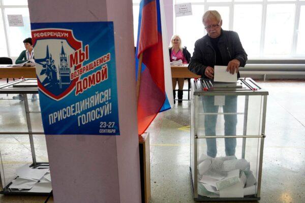 A man casts his ballot for a Russia-backed referendum at a polling station in Mariupol in Donetsk Oblast on Sept. 27, 2022. (Stringer/AFP via Getty Images)
