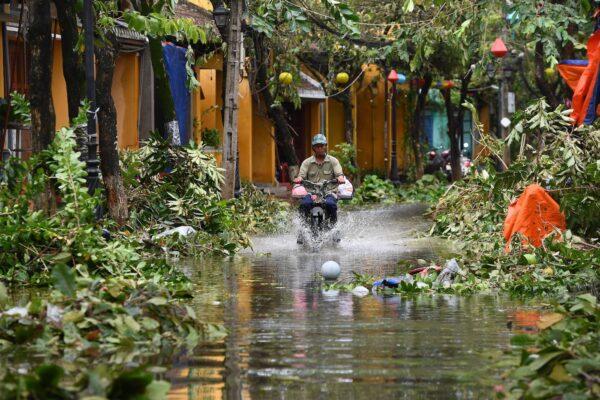 A man rides a motorbike in a flooded street following the passage of Typhoon Noru in Hoi An, Quang Nam Province, Vietnam, on Sept. 28, 2022. (Nhac Nguyen/AFP via Getty Images)