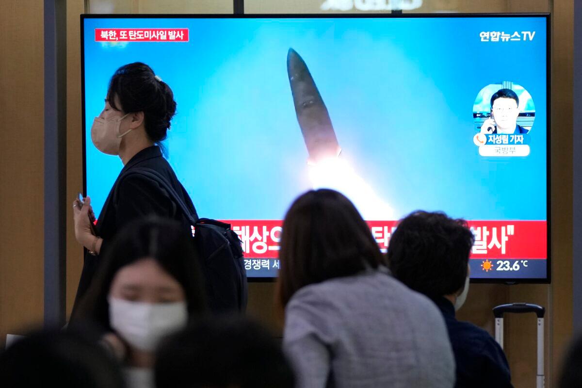 A TV screen shows a file image of a North Korean missile launch during a news program at the Seoul Railway Station in Seoul, South Korea, on Sept. 28, 2022. (Ahn Young-joon/AP Photo)