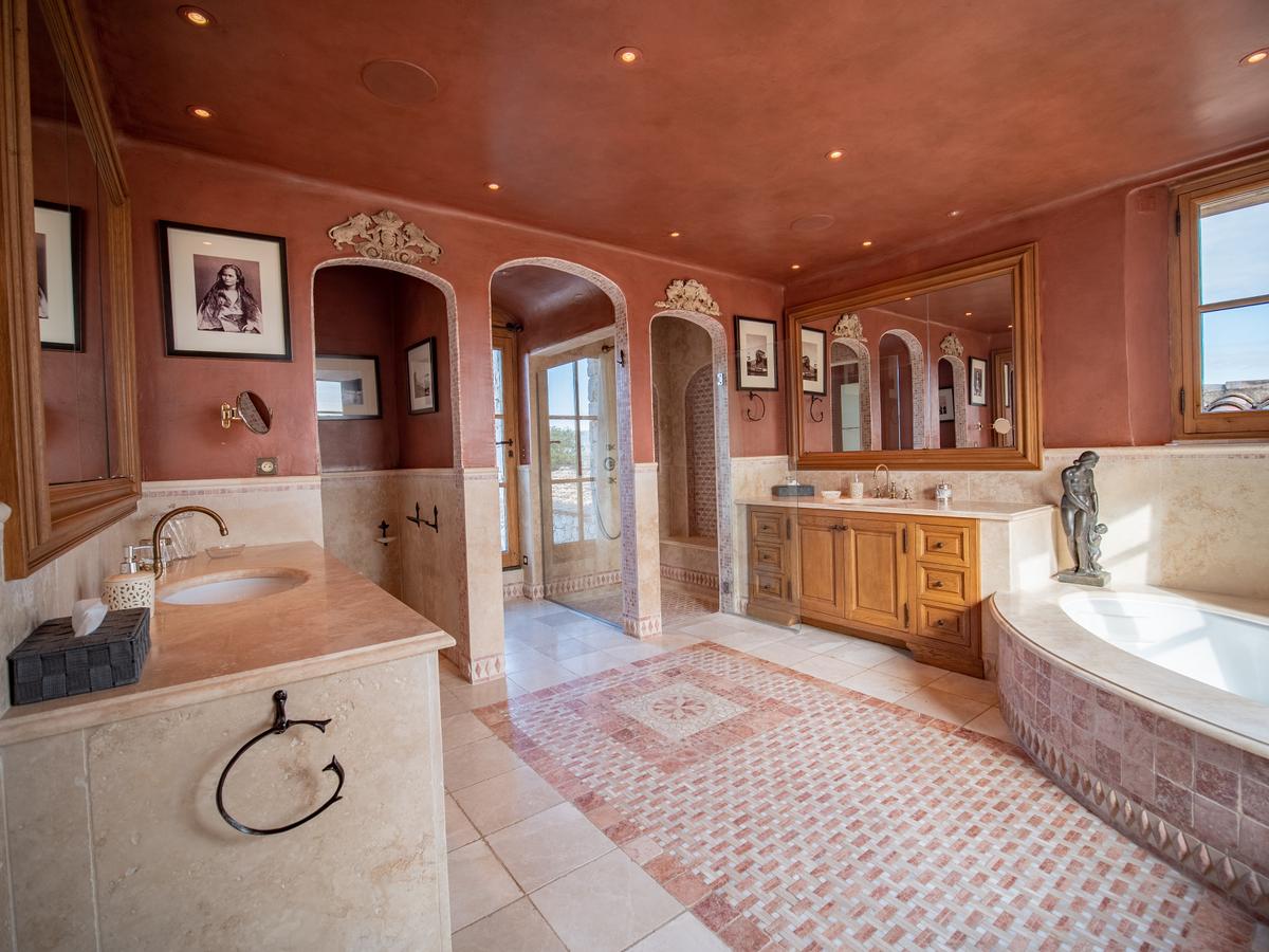 The master bath features exquisite stonework, tile, fixtures, and workmanship. (Courtesy of the property owners & Carlton International)
