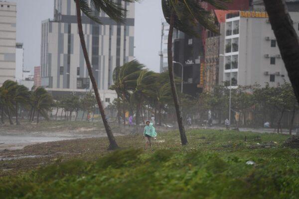A man walks along the beach following the passage of Typhoon Noru in Danang, Vietnam, on Sept. 28, 2022. (Nhac NguyenAFP via Getty Images)