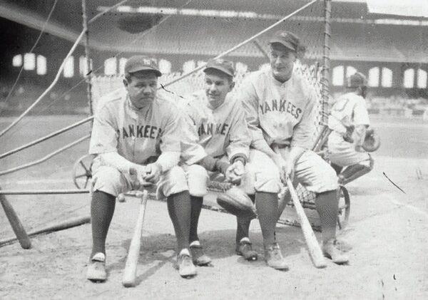 New York Yankees players (L to R) Babe Ruth, Bob Shawkey, and Gehrig sit on a batting practice backstop at Comiskey Park in Chicago, 1930. ( Public domain)