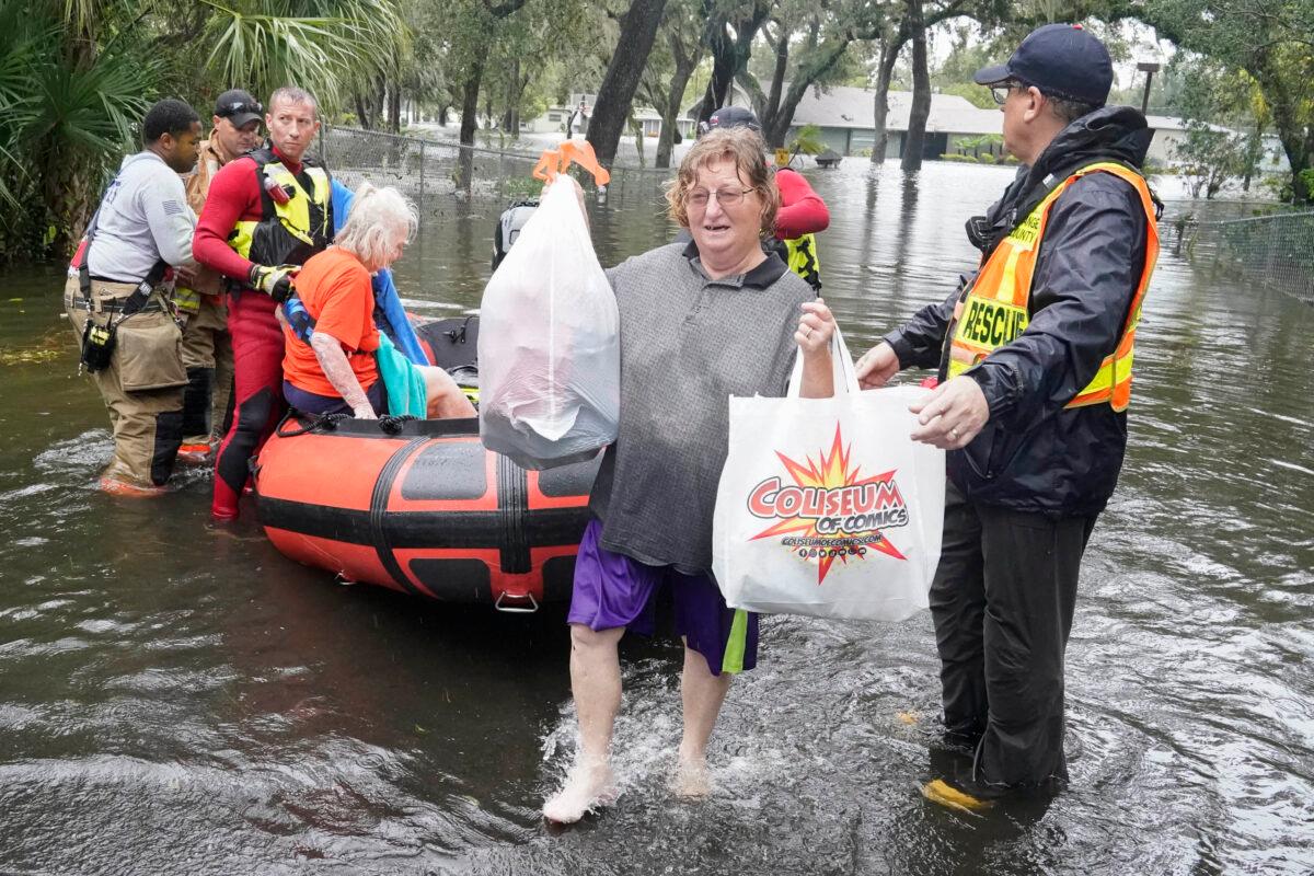 Residents are rescued from floodwaters in the aftermath of Hurricane Ian in Orlando, Fla., on Sept. 29, 2022. (John Raoux/AP Photo)