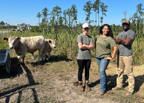 Veterans-turned-farmers Lizzie Hubbard (L) and Donovan Holloway (R), with his wife, Lauren, on the Veterans Farm of North Carolina. (Courtesy of William Holloway)