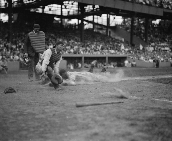 Gehrig scores head-first in the fourth inning as Joe Harris’s throw gets away from catcher Hank Severeid of the Washington Senators, 1925. (Library of Congress)