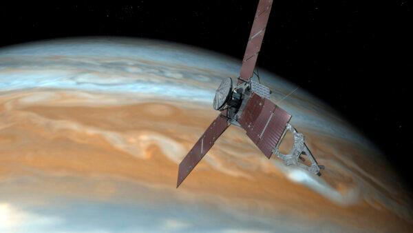 This illustration depicts NASA's Juno spacecraft making one of its close passes over Jupiter. (NASA via AP)