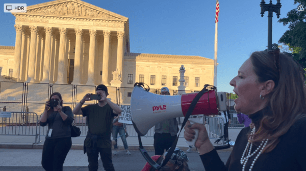 Theresa Brennan, president of the Right to Life League, speaks through a bull horn in front of the Supreme Court to defend the draft decision to overturn Roe v. Wade, which was leaked in May 2022. (Courtesy of Susan Arnall)