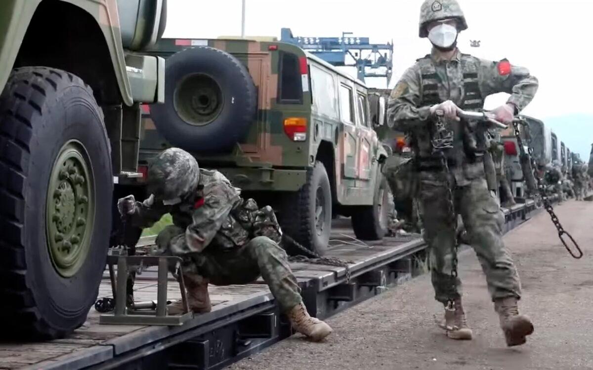 Chinese soldiers arrive to the Grodekovo railway station to participate in war games drills, in Grodekovo, Primorsky Krai, Russia, in a still from video released on Aug. 29. 2022. (Russian Defense Ministry Press Service via AP)