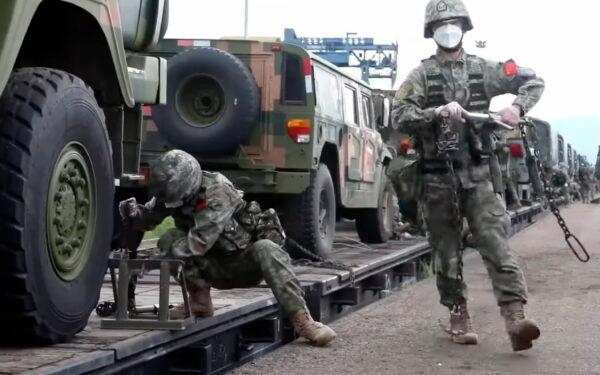 Chinese soldiers arrive at the Grodekovo railway station to participate in war games drills, in Grodekovo, Primorsky Krai, Russia, in a still from video released on Aug. 29, 2022. (Russian Defense Ministry Press Service via AP)