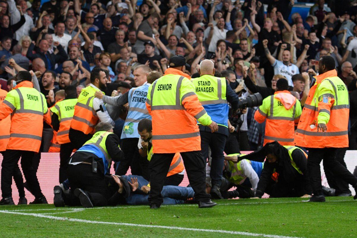 Leeds fans invade the pitch during the English Premier League football match between Leeds United and West Ham United at Elland Road in Leeds, northern England, on Sept. 25, 2021. (Oli Scarff/AFP via Getty Images)