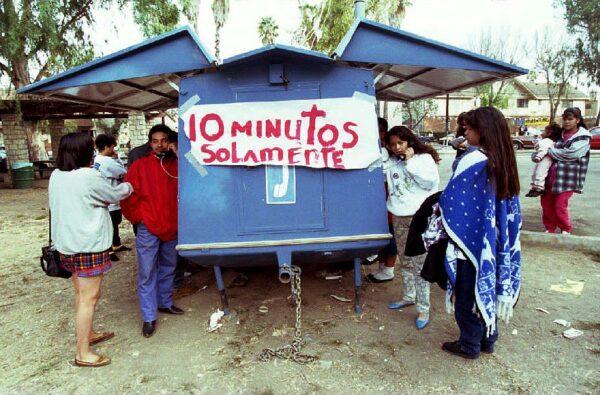 People left homeless by the Northridge earthquake line up to make phone calls in a remote telephone facility in Canoga Park, Calif., Jan. 22, 1994. (Mike Nelson/AFP via Getty Images)
