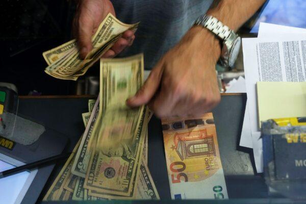 A cashier changes a 50 Euro banknote with U.S. dollars at an exchange counter in Rome, Italy, on July 13, 2022. (Gregorio Borgia/AP Photo)