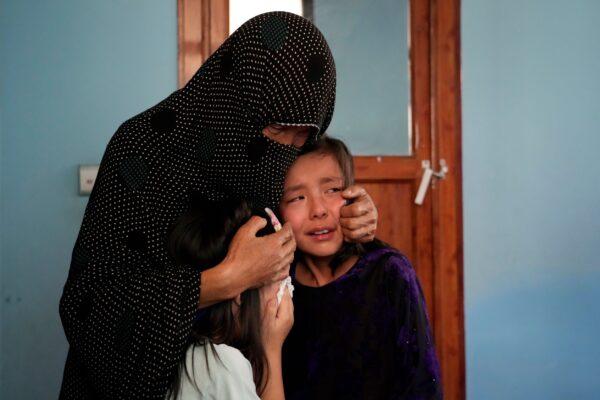 The family of a 19-years old girl who was victim of a suicide bomber mourns, in Kabul, Afghanistan, on Sept. 30, 2022. (Ebrahim Noroozi/AP Photo)