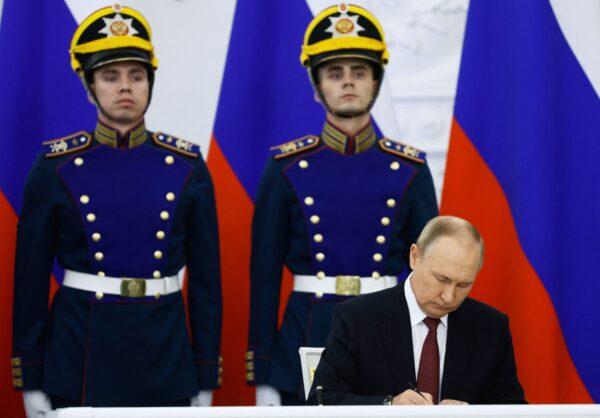 Russian President Vladimir Putin signs treaties formally annexing four regions of Ukraine occupied by Russian troops—Lugansk, Donetsk, Kherson, and Zaporizhzhia—at the Kremlin in Moscow on September 30, 2022. (Photo by Dmitry Astakhov/SPUTNIK/AFP via Getty Images)