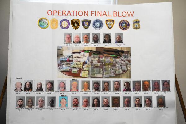 Pictures and names of defendants arrested due to a major drug raid targeting operations in Port Jervis are displayed during a press conference at the Port Jervis City Hall in N.Y. on Sept. 28, 2022. (Cara Ding/The Epoch Times)
