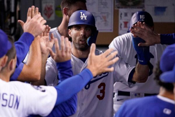 Los Angeles Dodgers' Chris Taylor is congratulated by teammates in the dugout after scoring on a double by Mookie Betts during the second inning of a baseball game against the Colorado in Los Angeles, on Sept. 30, 2022. (Mark J. Terrill/AP Photo)