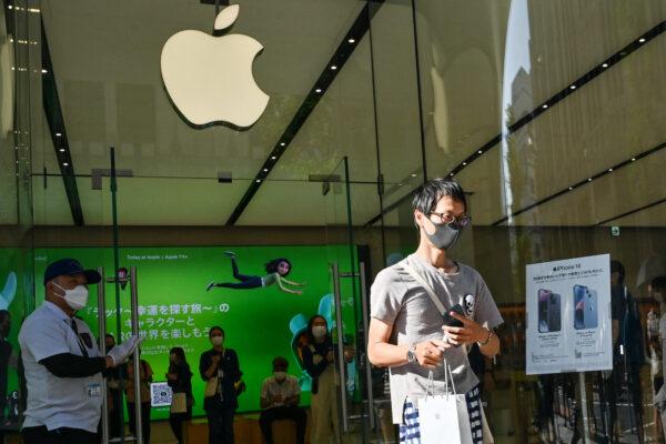 A customer departs an Apple store after people queued up for the launch of the new iPhone 14 in Tokyo on Sept. 16, 2022. (Richard A. Brooks/AFP via Getty Images)