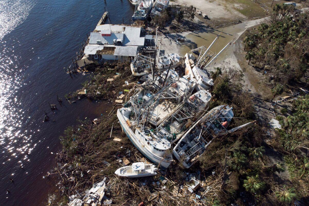 Stranded shrimp boats in a marina after Hurricane Ian caused widespread destruction in Fort Myers Beach, Fla., on Sept. 30, 2022. (Marco Bello/Reuters)