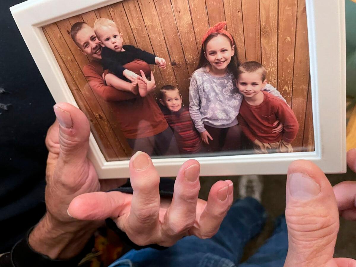 (L–R) Brian Anthony Nelson II, Kurgan Nelson, Ragnar Nelson, Brantley Nelson, and Vegeta Nelson are seen in a framed photograph in their grandparents apartment in Tulsa, Okla., on Oct. 28, 2022. (Andrea Eger/Tulsa World via AP)