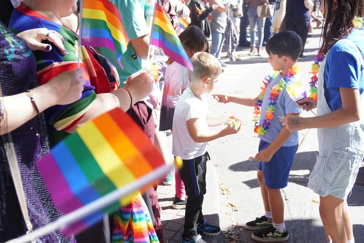 A little boy reaches for candy from the Chattanooga Pride parade in Chattanooga, Tenn., on Oct. 2, 2022. (Jackson Elliott/The Epoch Times)