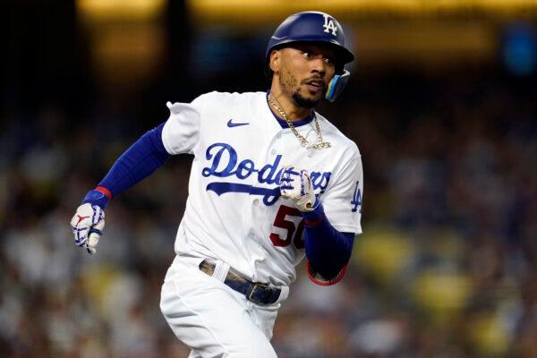 Los Angeles Dodgers' Mookie Betts rounds first base as he doubles during the third inning of a baseball game against the Colorado Rockies in Los Angeles, Oct. 1, 2022. (Marcio Jose Sanchez/AP Photo)